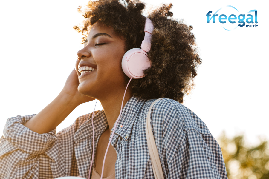 Person listening to music, points to Freegal site.